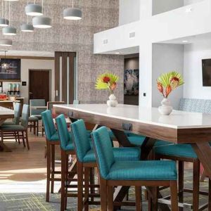 bright-lit, comfortable lobby-lounge and coworking space at Hampton Inn & Suites Sunnyvale Silicon Valley.