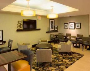Restaurant area with chairs and tables perfect as workplace at the Hampton Inn Boston Bedford Burlington.