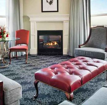 Bright and comfortable presidential suite with sofas and fireplace at the Embassy Suites by Hilton Portland-Downtown.