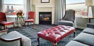 Bright and comfortable presidential suite with sofas and fireplace at the Embassy Suites by Hilton Portland-Downtown.