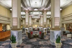 Elegant lobby area with tables and chairs perfect as workspace at the Embassy Suites by Hilton Portland-Downtown.