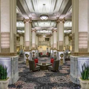 Elegant lobby area with tables and chairs perfect as workspace at the Embassy Suites by Hilton Portland-Downtown.