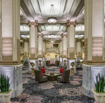 Elegant lobby area with tables and chairs perfect as workspace at the Embassy Suites by Hilton Portland-Downtown.