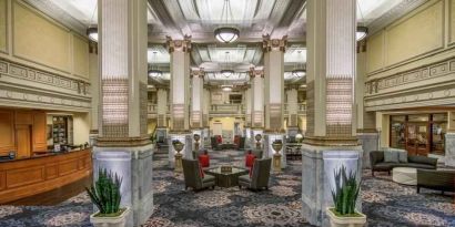 Elegant lobby area with tables and chairs perfect as workspace at the Embassy Suites by Hilton Portland-Downtown.