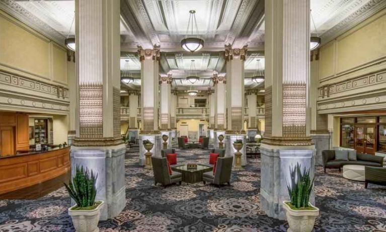 Elegant lobby area with tables and chairs perfect as workspace at the Embassy Suites by Hilton Portland-Downtown.