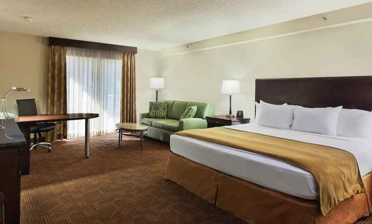 luxurious king suite with work desk and lounge area at DoubleTree by Hilton Hotel Sacramento.