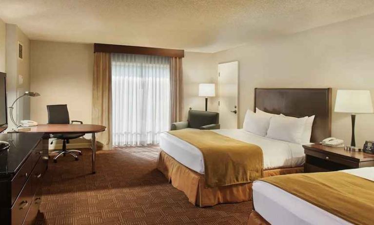 beautiful queen bedroom work desk and TV at DoubleTree by Hilton Hotel Sacramento.