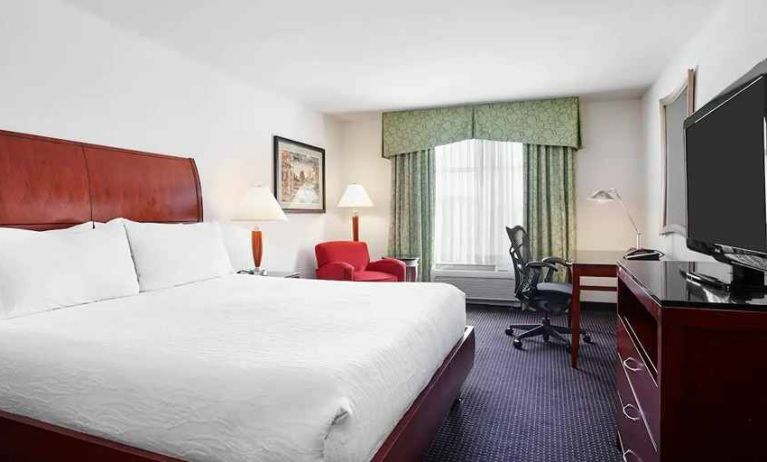 spacious king room with work area and lounge at Hilton Garden Inn Rockville-Gaithersburg.