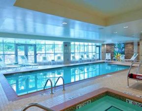 beautiful indoor pool with seating at Hilton Garden Inn Rockville-Gaithersburg.