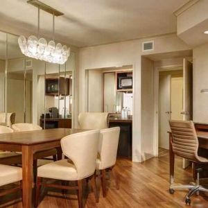 Desk, table and chairs in a presidential suite dining area at the Embassy Suites by Hilton San Diego-La Jolla.