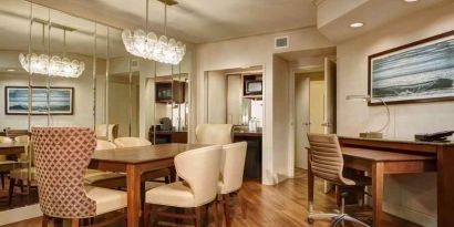 Desk, table and chairs in a presidential suite dining area at the Embassy Suites by Hilton San Diego-La Jolla.