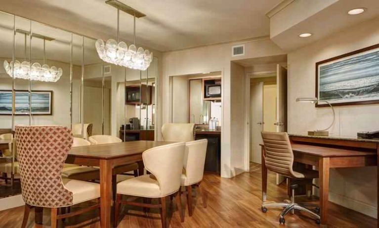 Desk, table and chairs in a presidential suite dining area at the Embassy Suites by Hilton San Diego-La Jolla.