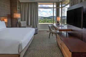 Executive king bedroom with desk, window and TV screen at the Hilton Franklin Cool Springs.