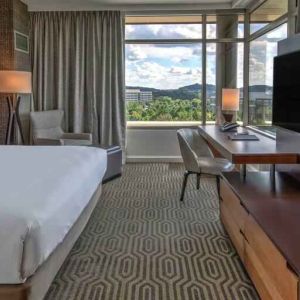 Executive king bedroom with desk, window and TV screen at the Hilton Franklin Cool Springs.