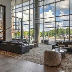 Beautiful lobby area with large windows and lounges perfect as workspace at the Hilton Franklin Cool Springs.