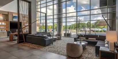 Beautiful lobby area with large windows and lounges perfect as workspace at the Hilton Franklin Cool Springs.