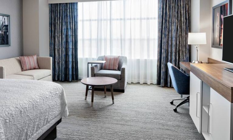 King size bed, sofas and desk in a king room at the Hampton Inn Chicago McCormick Place.