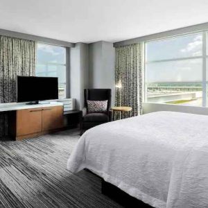 King suite with desk and large windows at the Hilton Garden Inn Chicago McCormick Place.