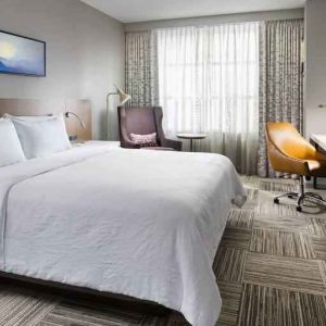 King size bed, TV screen and desk at the Hilton Garden Inn Chicago McCormick Place.