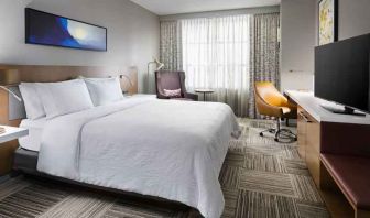 King size bed, TV screen and desk at the Hilton Garden Inn Chicago McCormick Place.