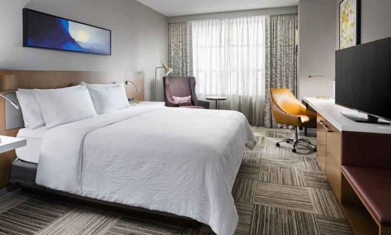 King size bed, TV screen and desk at the Hilton Garden Inn Chicago McCormick Place.