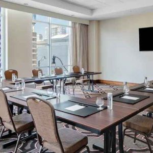 Small meeting room with screen at the Hilton Garden Inn Chicago McCormick Place.