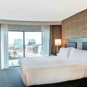 King bedroom with city view at the Embassy Suites by Hilton Minneapolis-Airport.