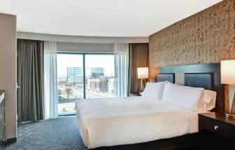 King bedroom with city view at the Embassy Suites by Hilton Minneapolis-Airport.