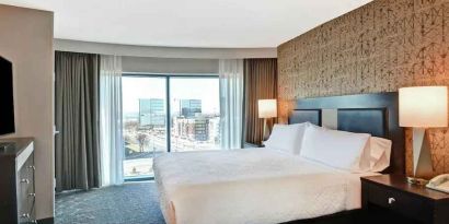 King bedroom with city view at the Embassy Suites by Hilton Minneapolis-Airport.