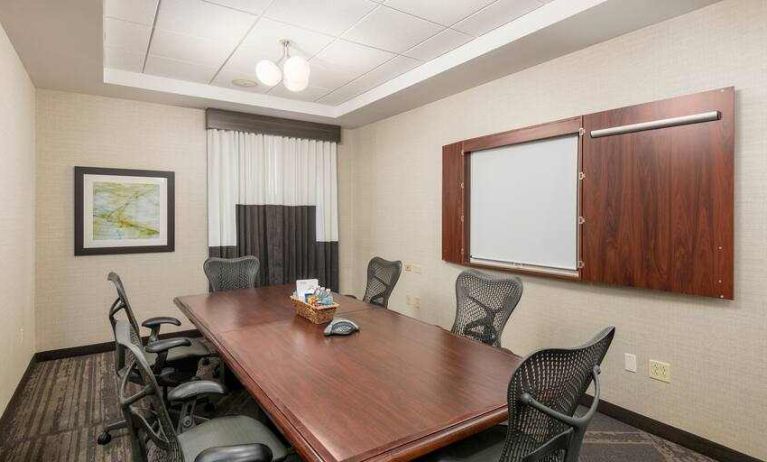 Small meeting room with screen at the Hilton Garden Inn Silver Spring White Oak.