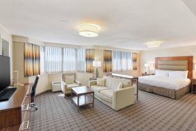 Beautiful king suite with desk, TV screen and sofa at the Hilton Crystal City at Washington Reagan National Airport.