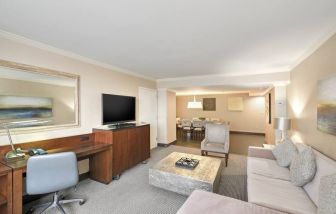 Elegant and spacious presidential suite with working station at the Hilton Crystal City at Washington Reagan National Airport.