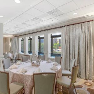 Elegant event room with chairs and tables at the Hilton Crystal City at Washington Reagan National Airport.