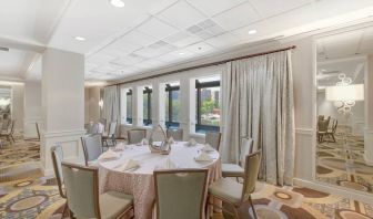 Elegant event room with chairs and tables at the Hilton Crystal City at Washington Reagan National Airport.