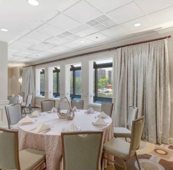 Elegant event room with chairs and tables at the Hilton Crystal City at Washington Reagan National Airport.