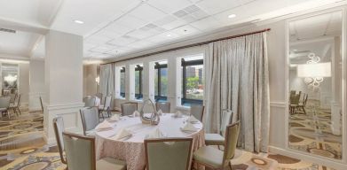 Elegant event room with chairs and tables at the Hilton Crystal City at Washington Reagan National Airport.