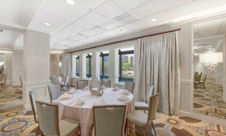 Elegant event room with chairs and tables at the Hilton Crystal City at Washington Reagan National Airport.