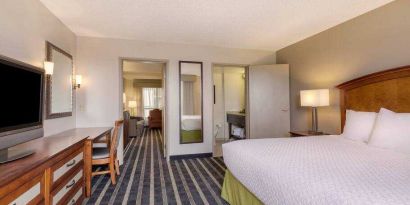 Spacious king suite with desk at the Embassy Suites by Hilton San Francisco Airport Waterfront.