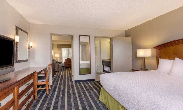 Spacious king suite with desk at the Embassy Suites by Hilton San Francisco Airport Waterfront.