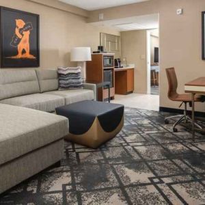 Living room with working station in a king suite at the Embassy Suites by Hilton San Francisco Airport.