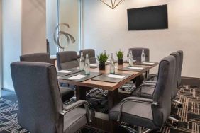 Small meeting room with TV screen at the Embassy Suites by Hilton San Francisco Airport.