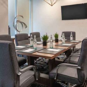 Small meeting room with TV screen at the Embassy Suites by Hilton San Francisco Airport.