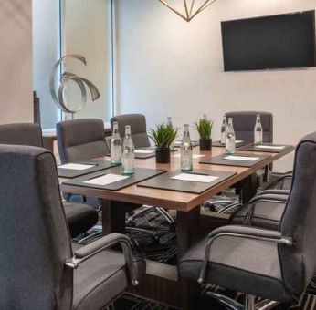 Small meeting room with TV screen at the Embassy Suites by Hilton San Francisco Airport.