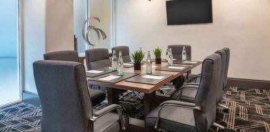 Small meeting room with TV screen at the Embassy Suites by Hilton San Francisco Airport.