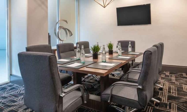 Small meeting room with TV screen at the Embassy Suites by Hilton San Francisco Airport.