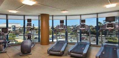 Fitness center with treadmills at the Embassy Suites by Hilton San Francisco Airport.