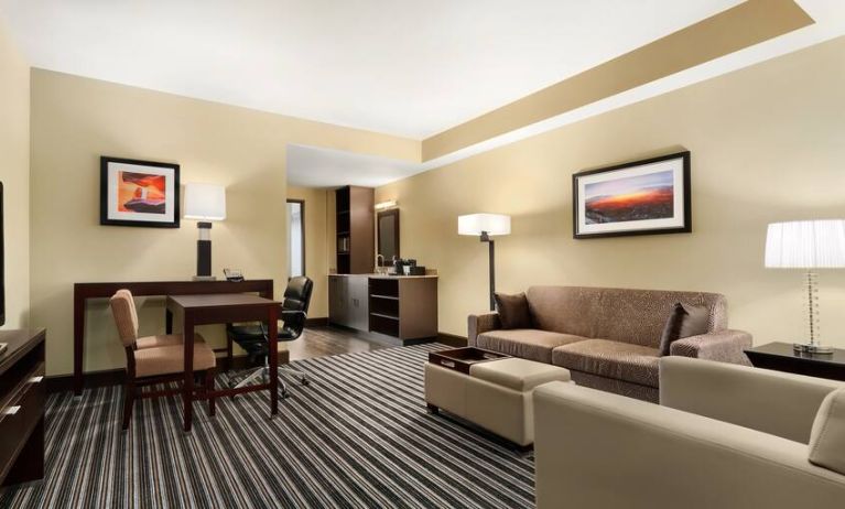 Living room with sofa and desk at the Embassy Suites by Hilton Salt Lake City West Valley.