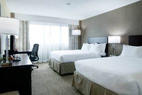 Spacious queen size room with 2 queen beds, desk, and chair at the Hilton Nashville Airport.