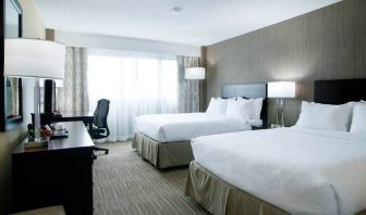 Spacious queen size room with 2 queen beds, desk, and chair at the Hilton Nashville Airport.