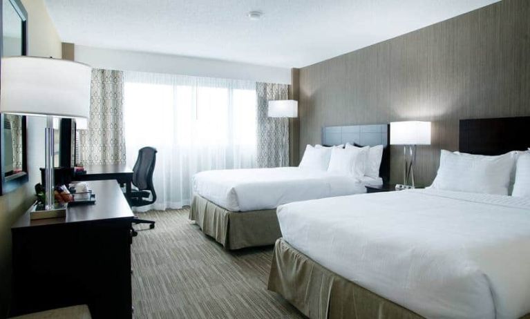 Spacious queen size room with 2 queen beds, desk, and chair at the Hilton Nashville Airport.